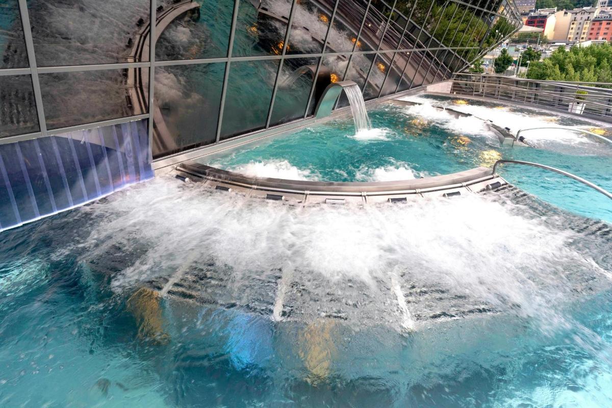 a water slide in a building with a waterfall