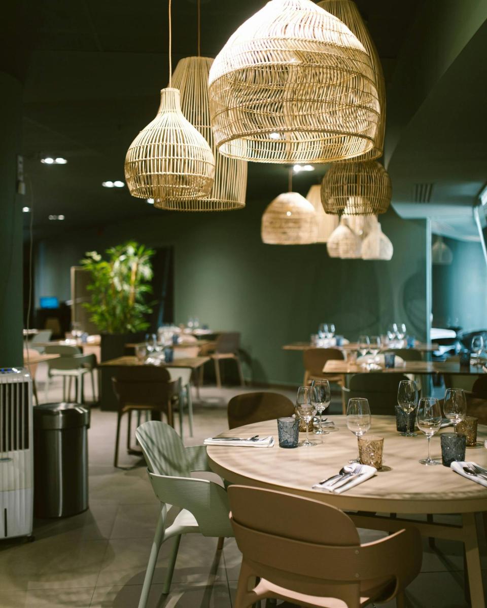 ein Restaurant mit einem Tisch mit Stühlen und Kronleuchtern