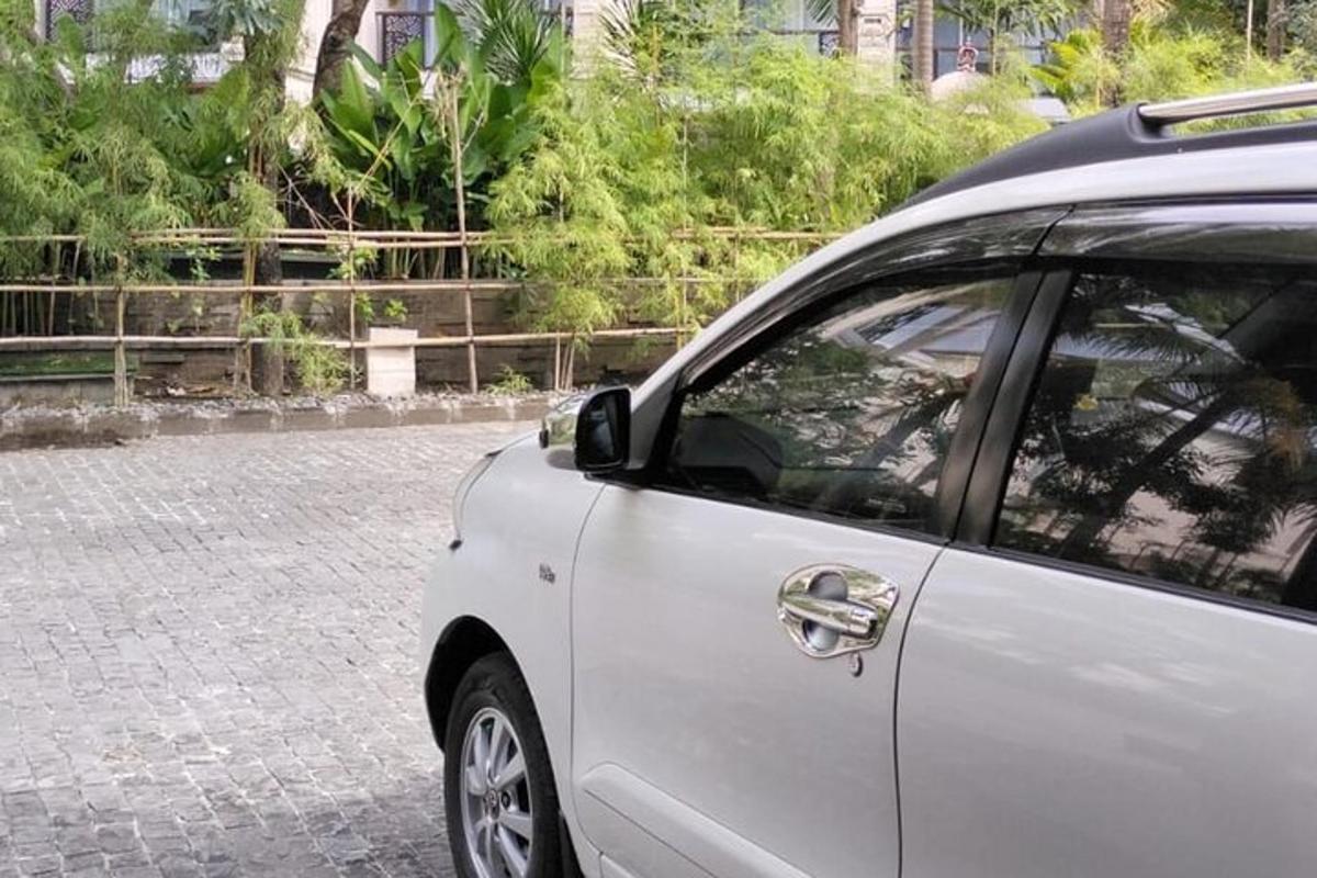 a white car parked on a brick road