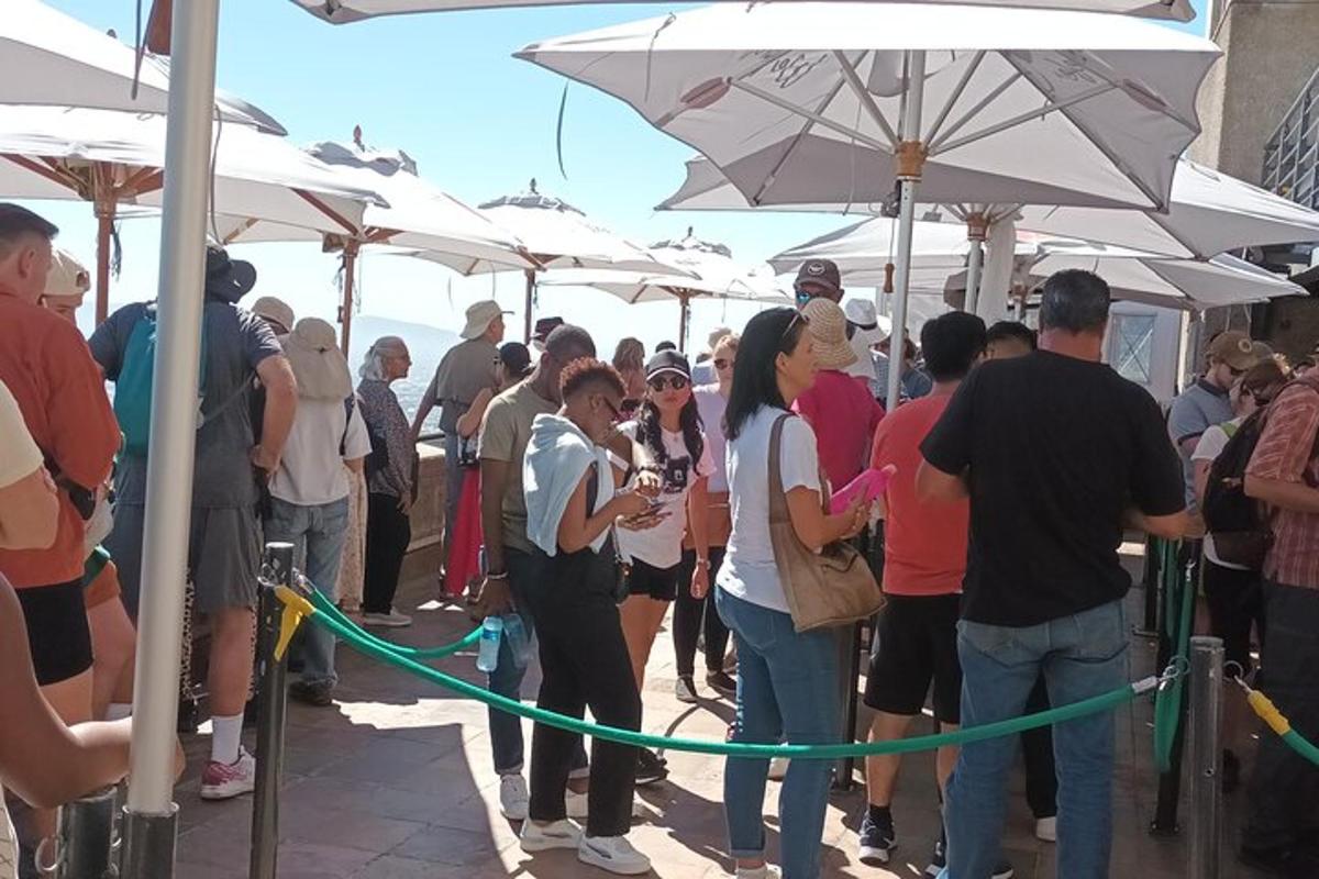 a crowd of people standing under white umbrellas