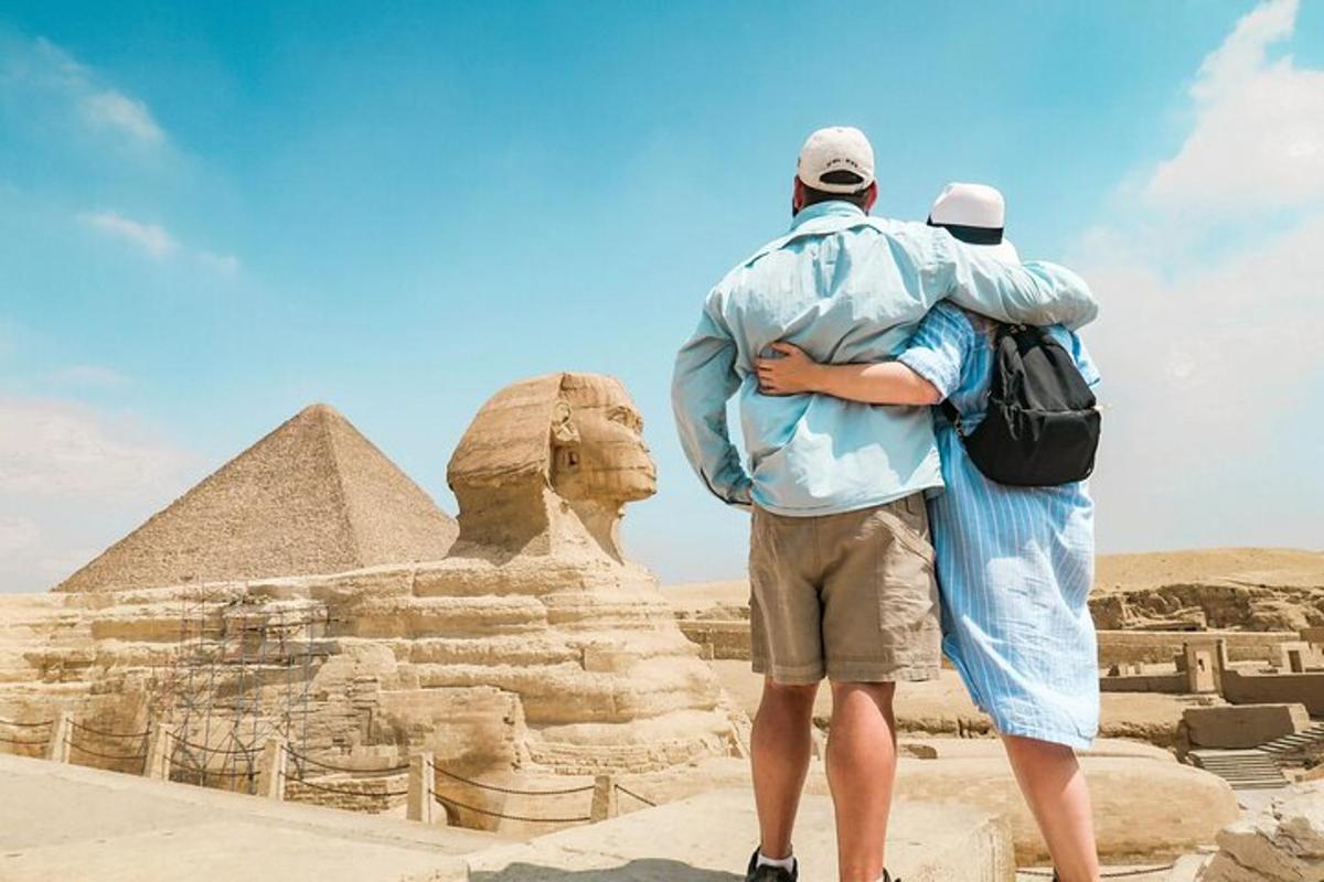 two men standing in front of the pyramids