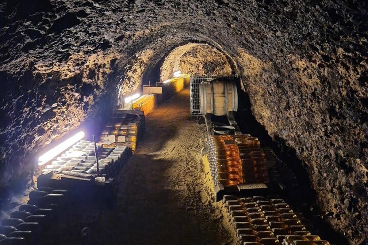 a dark cave with a tunnel with rows of seats