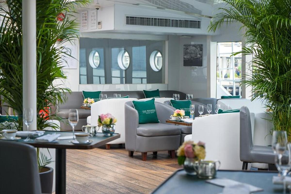 un restaurant amb cadires i taules blanques i coixins verds
