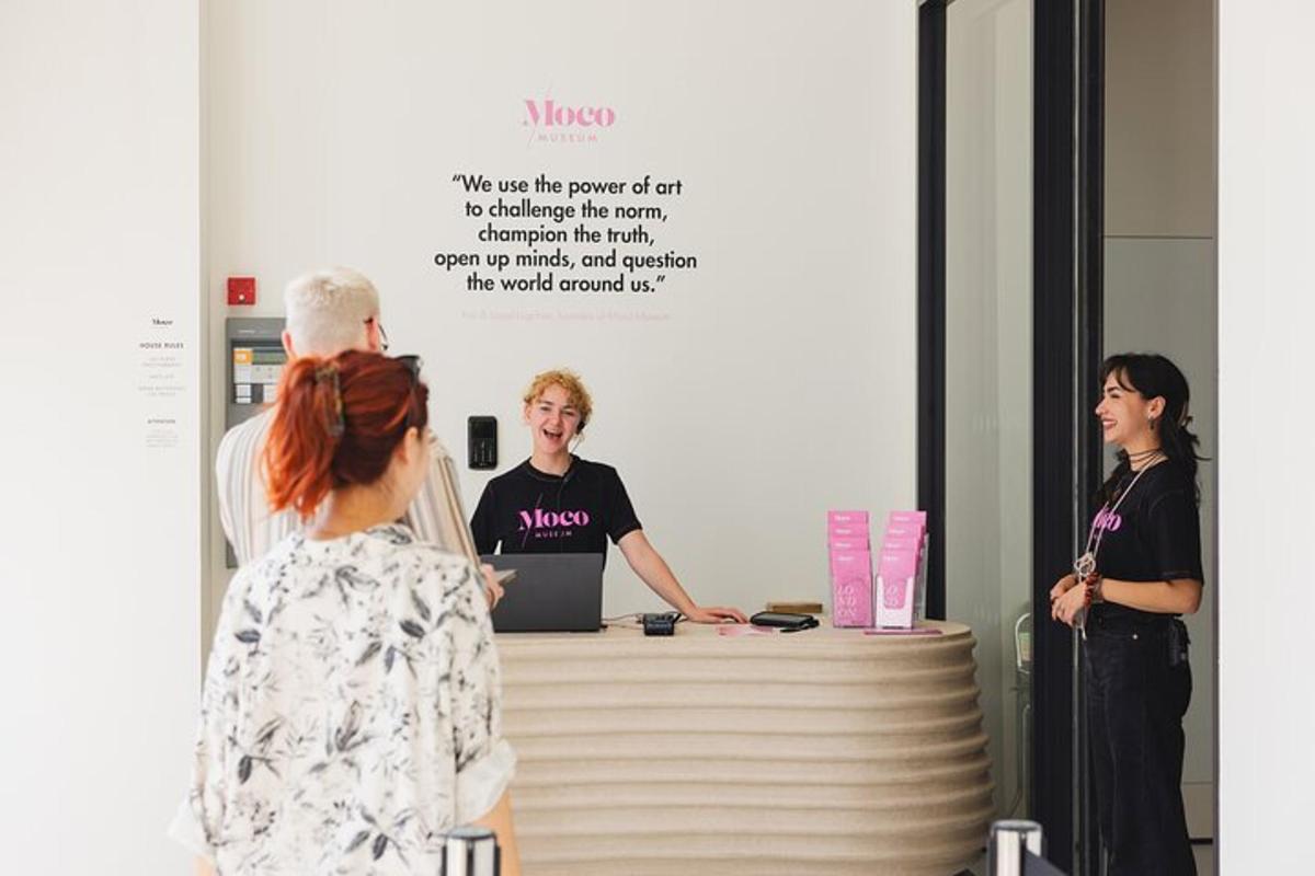 a group of people standing around a reception desk