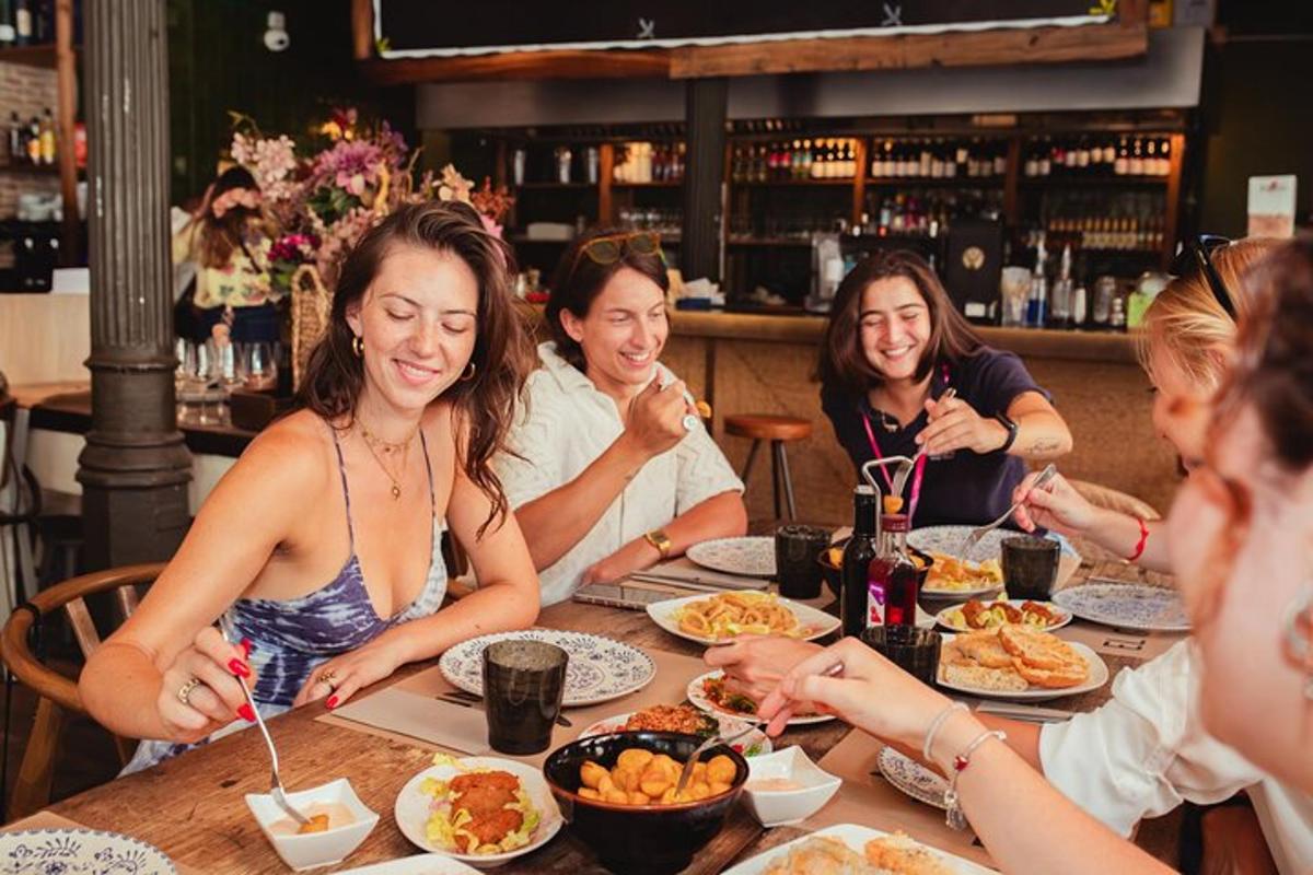 a group of people sitting around a table eating food