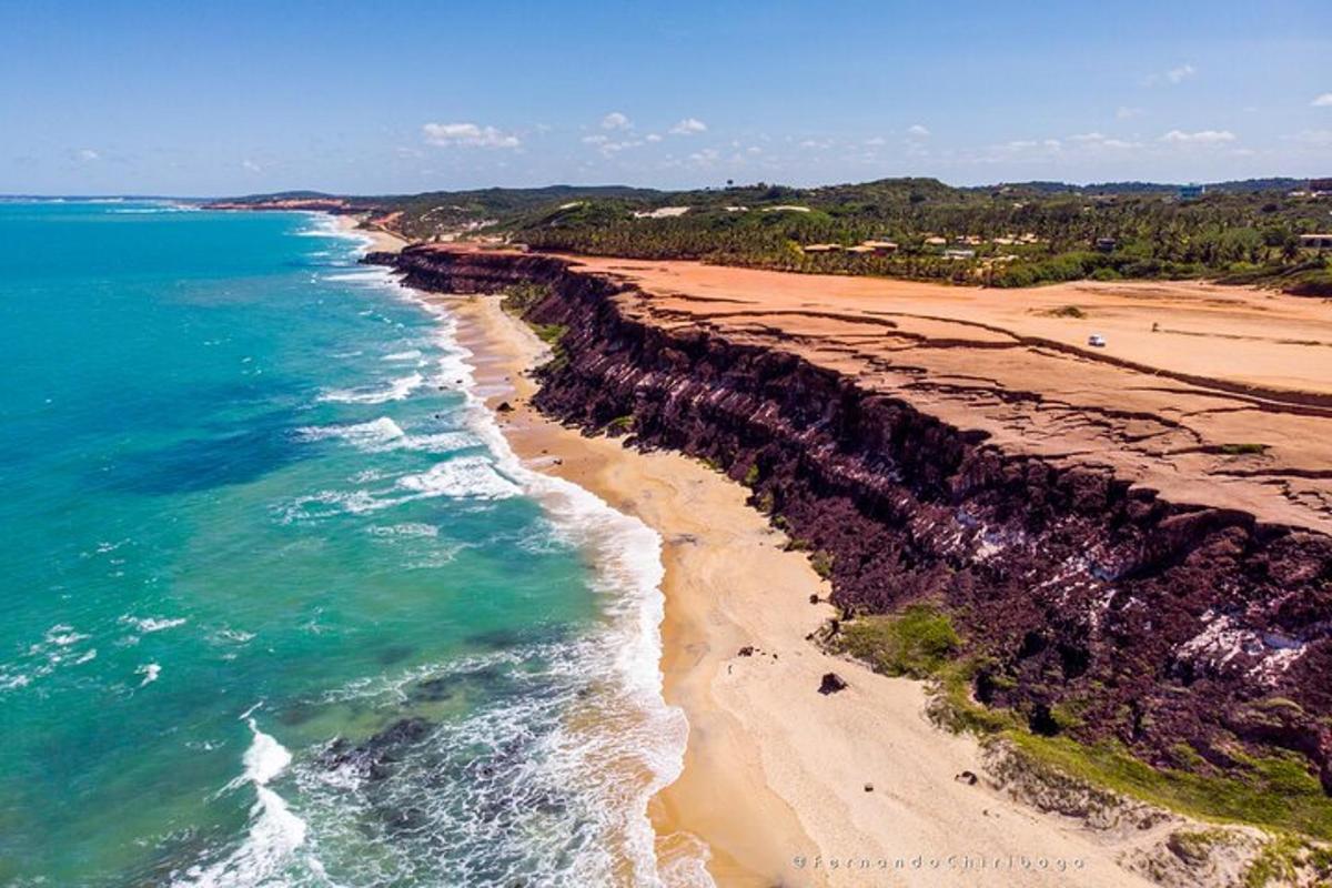 an aerial view of a beach next to the ocean
