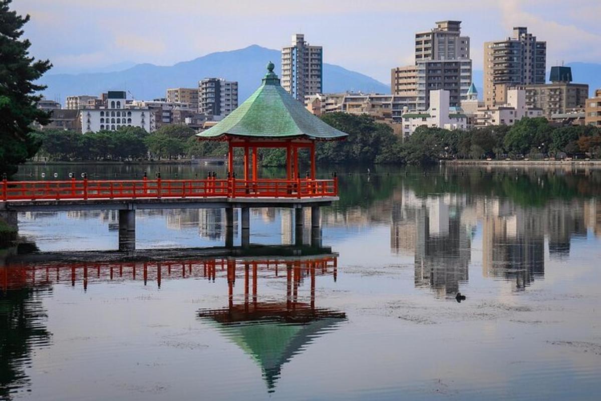 a gazebo in the middle of a lake with a city
