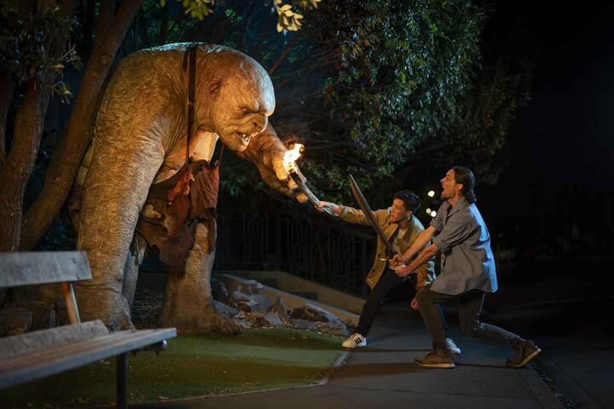 a man and woman standing next to a statue of an elephant