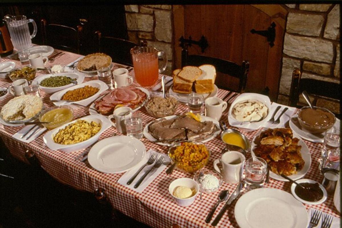 a table full of food on a red and white table cloth