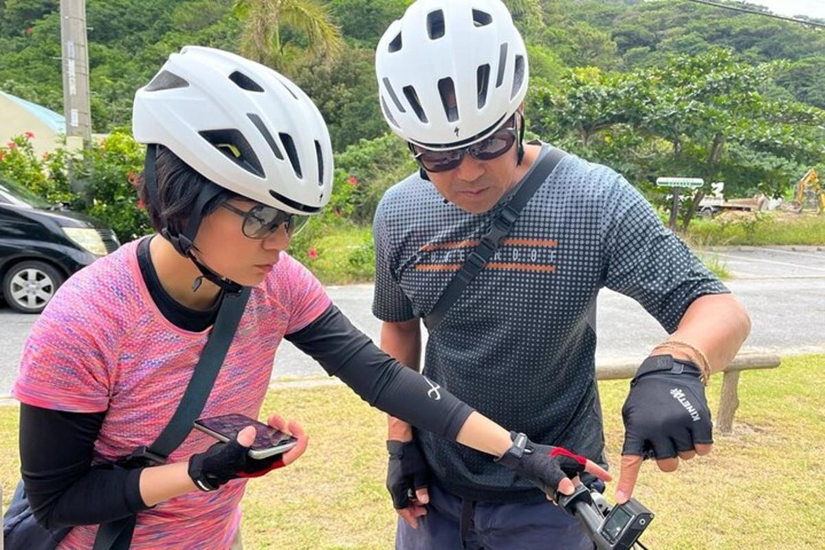 a man and a woman wearing helmets on a bike
