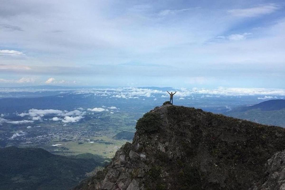 a person standing on the top of a mountain