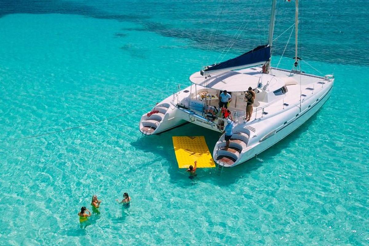 a group of people standing around a boat in the water