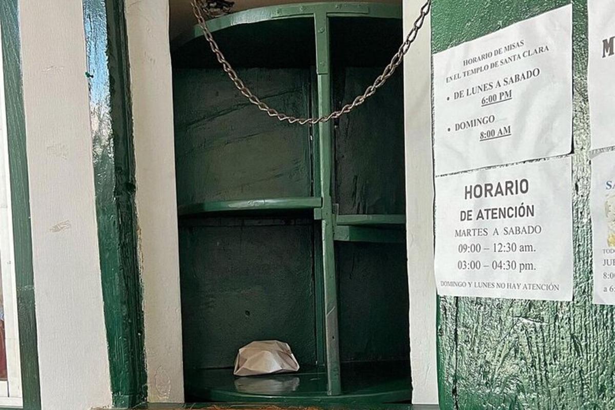 a glass door with a bag on the floor of a building
