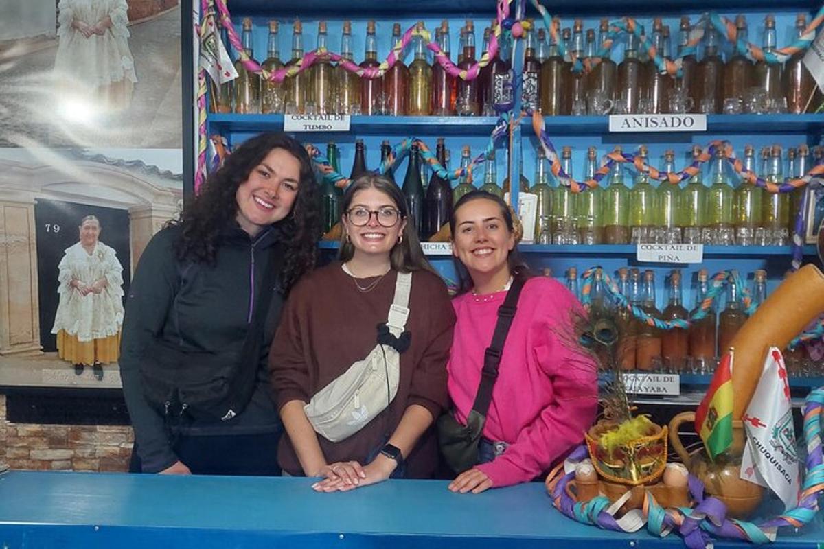 three women standing behind a counter in a store
