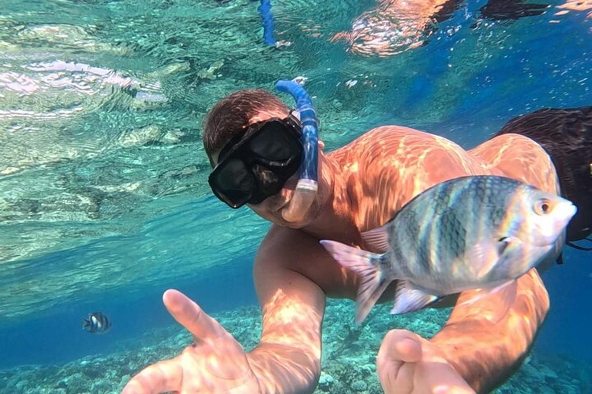 a man holding a fish in the water