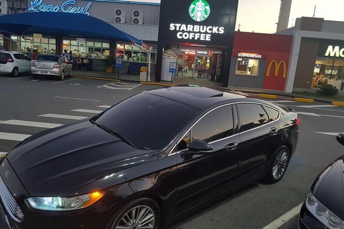 a black car is parked in a parking lot