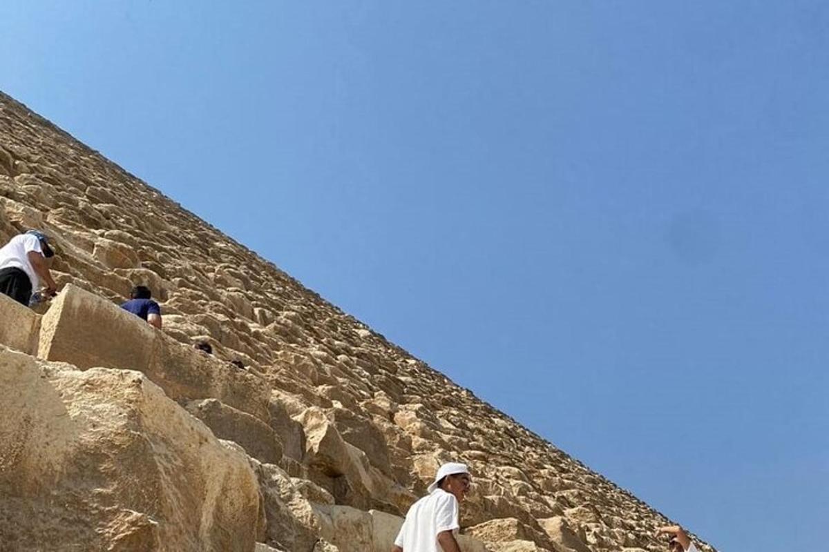 people walking up the stairs to the pyramid