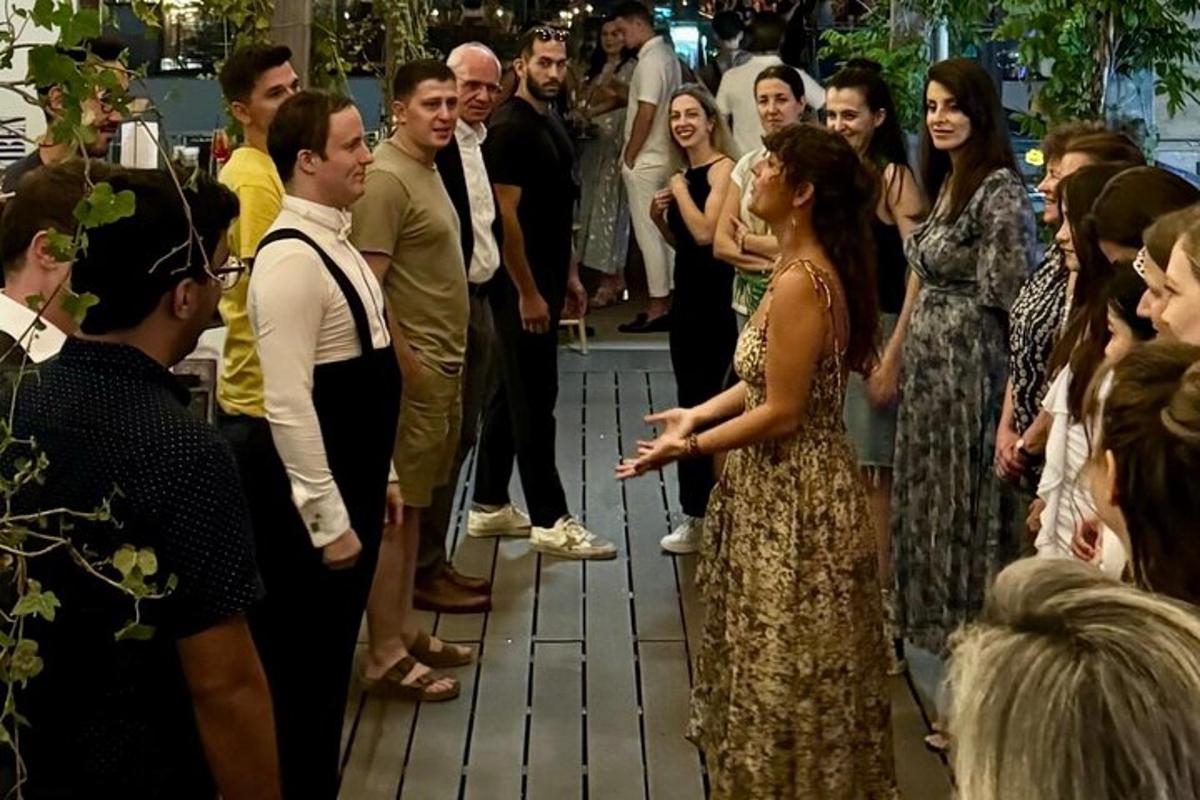 a woman in a dress talking to a crowd of people