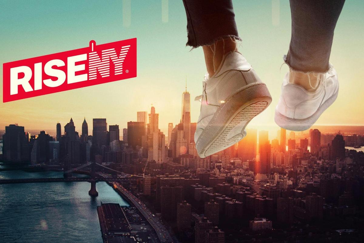 a person walking over a city with a rise sign