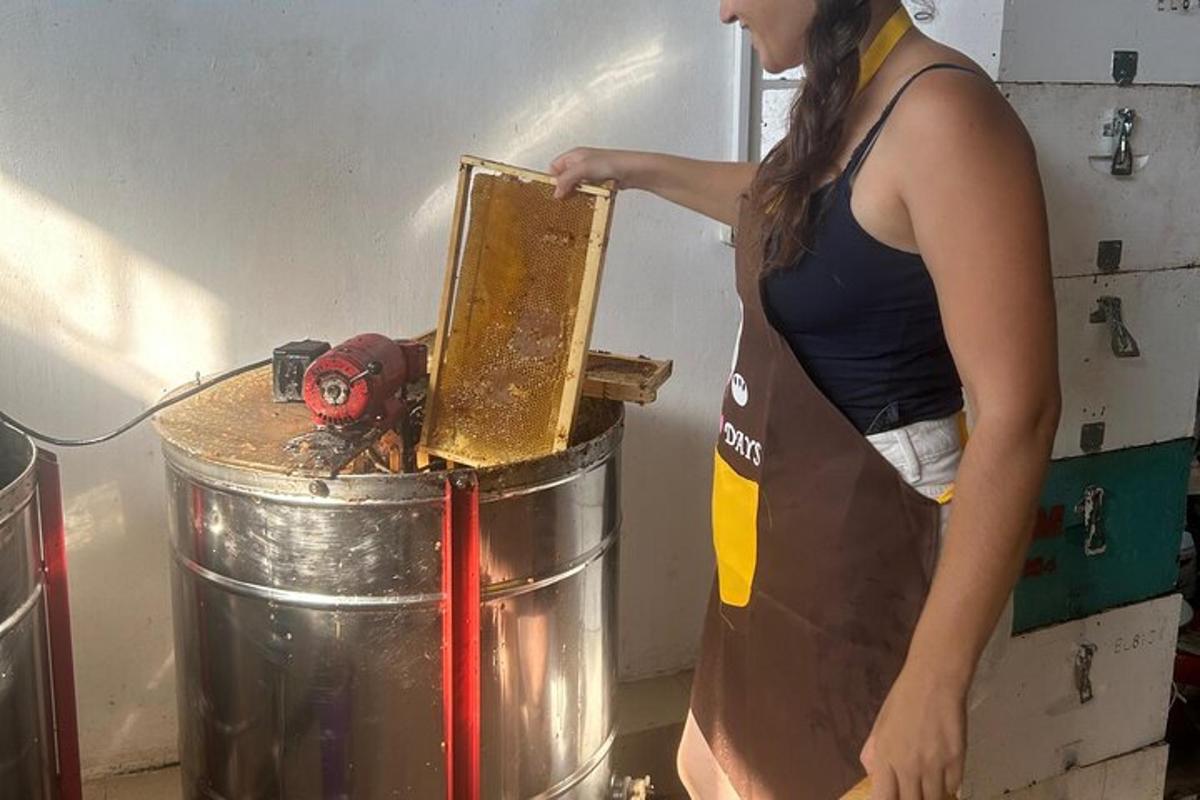 a woman in an apron standing next to a metal bucket