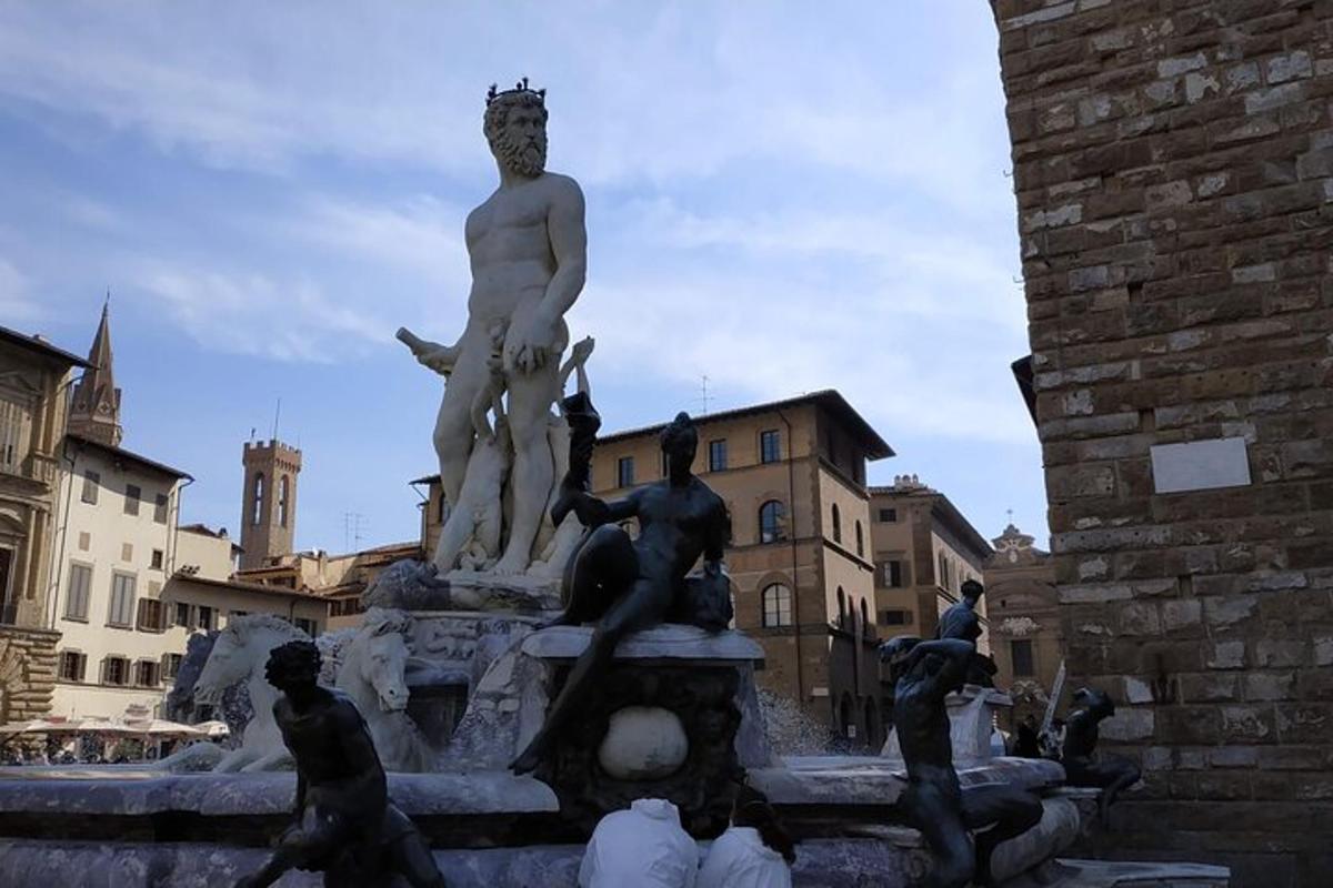 a statue of men sitting on top of a fountain