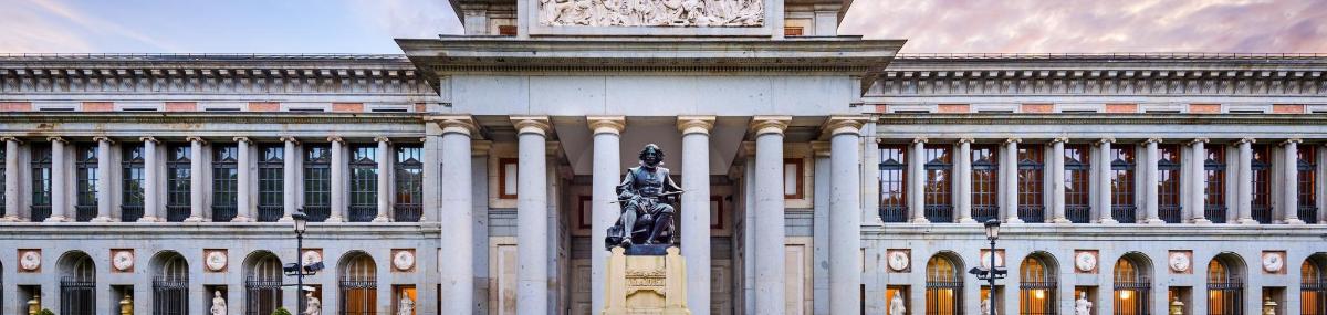 a large building with a statue in front of it