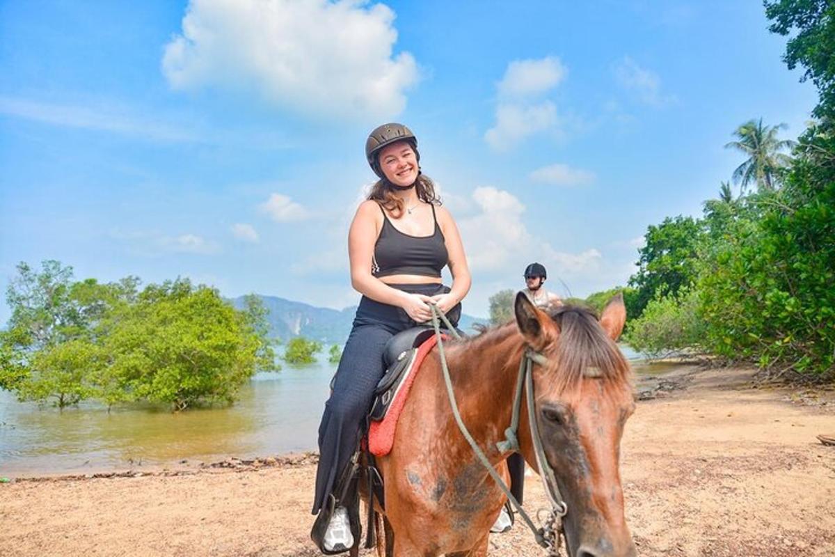 una mujer joven montando a caballo en la playa