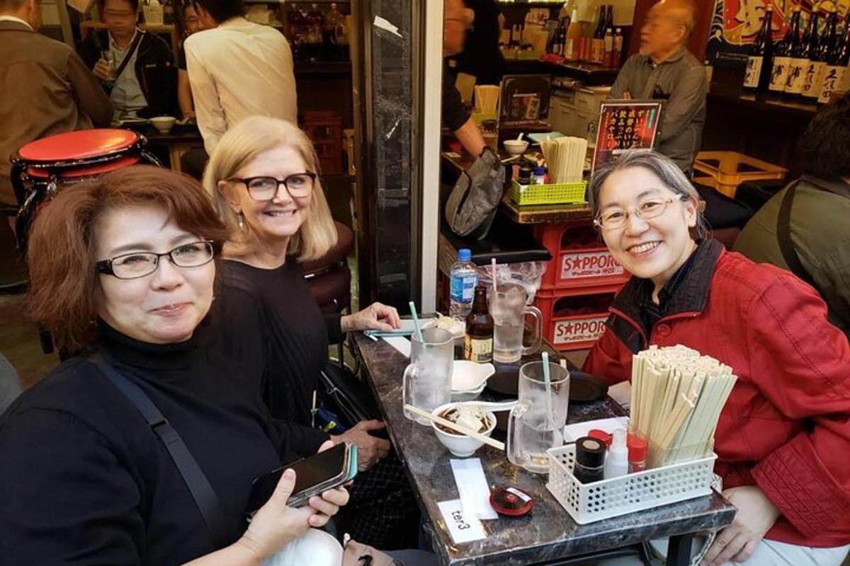 Un grupo de tres mujeres sentadas en una mesa en un restaurante.
