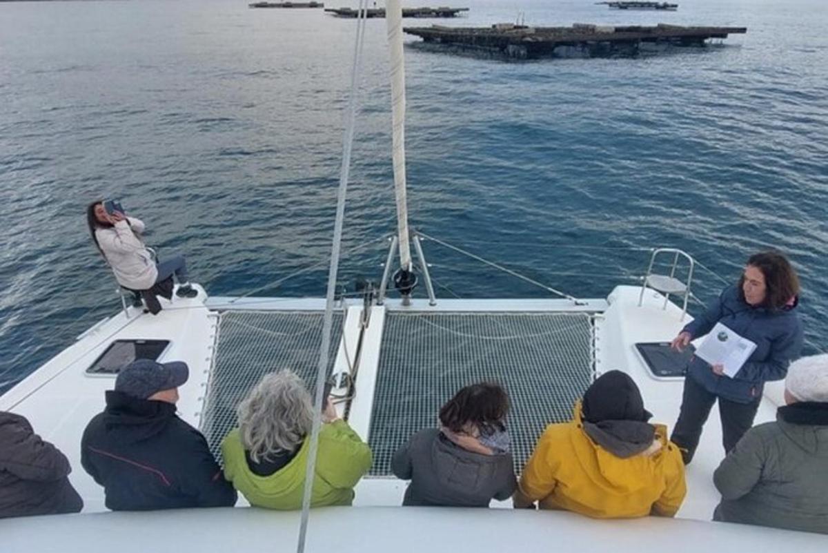 a group of people sitting on a boat in the water