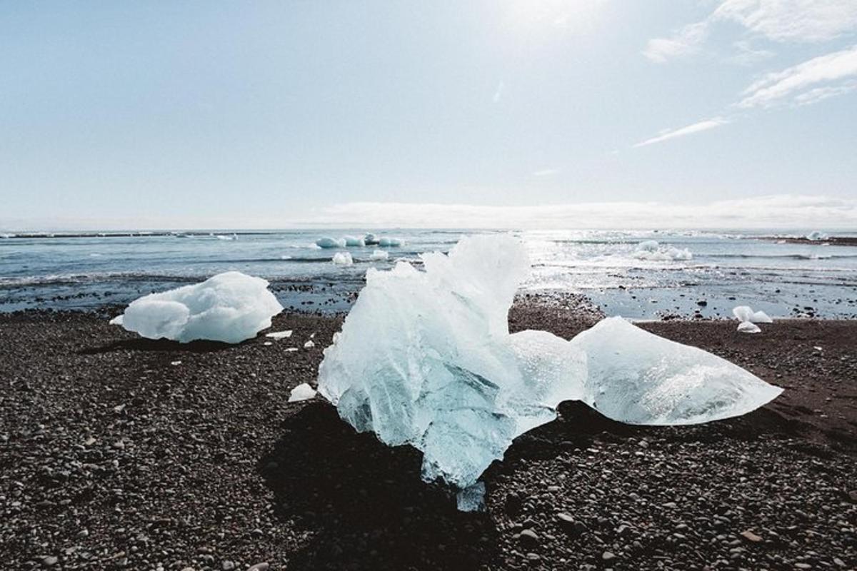 a block of ice on a beach near the water