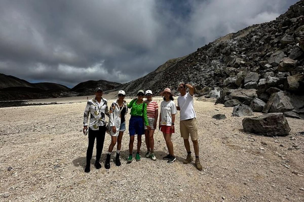 a group of people standing on a rocky beach
