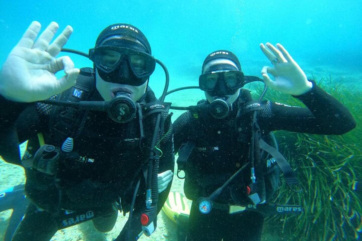 due persone in acqua con le mani in aria