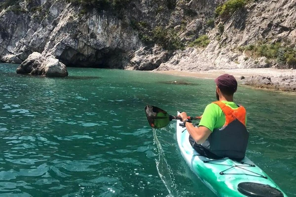 a woman sitting on a kayak in the water