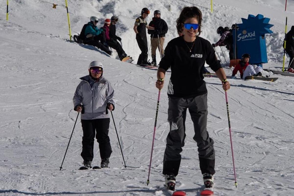 two men are standing in the snow on skis