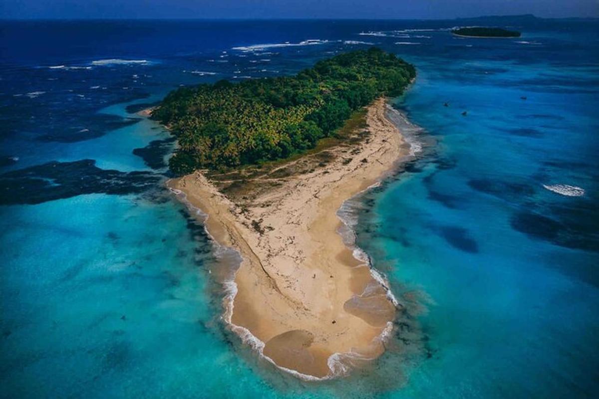 an island in the ocean next to the water