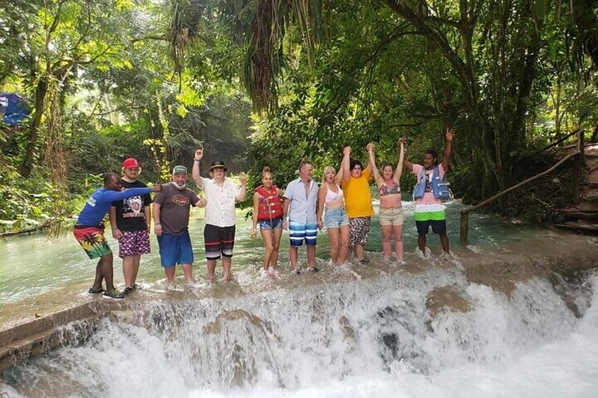 un gruppo di persone in piedi in cima a una cascata