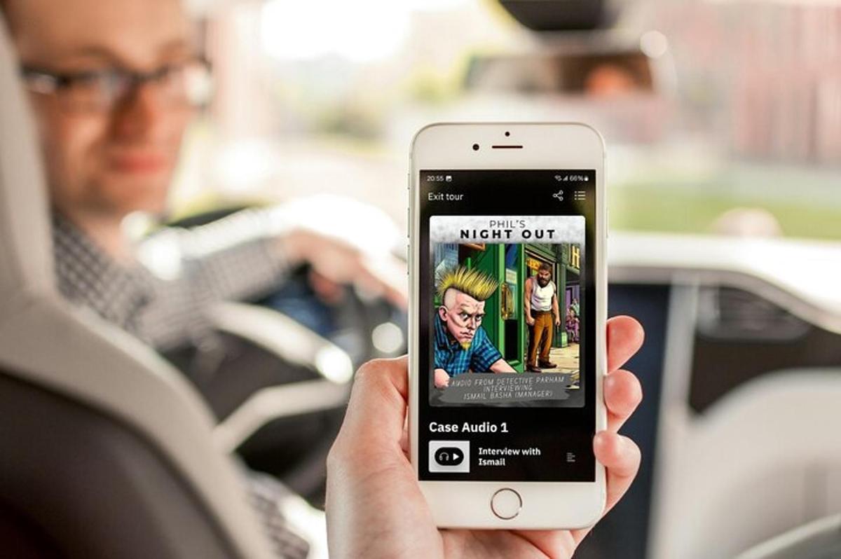 a person holding up a cell phone with a movie on it
