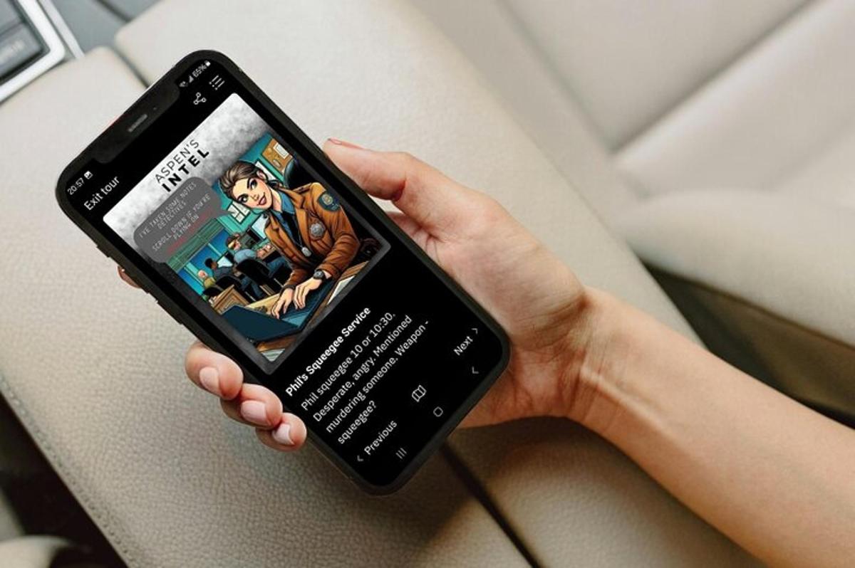 a person holding a cell phone with a book on it