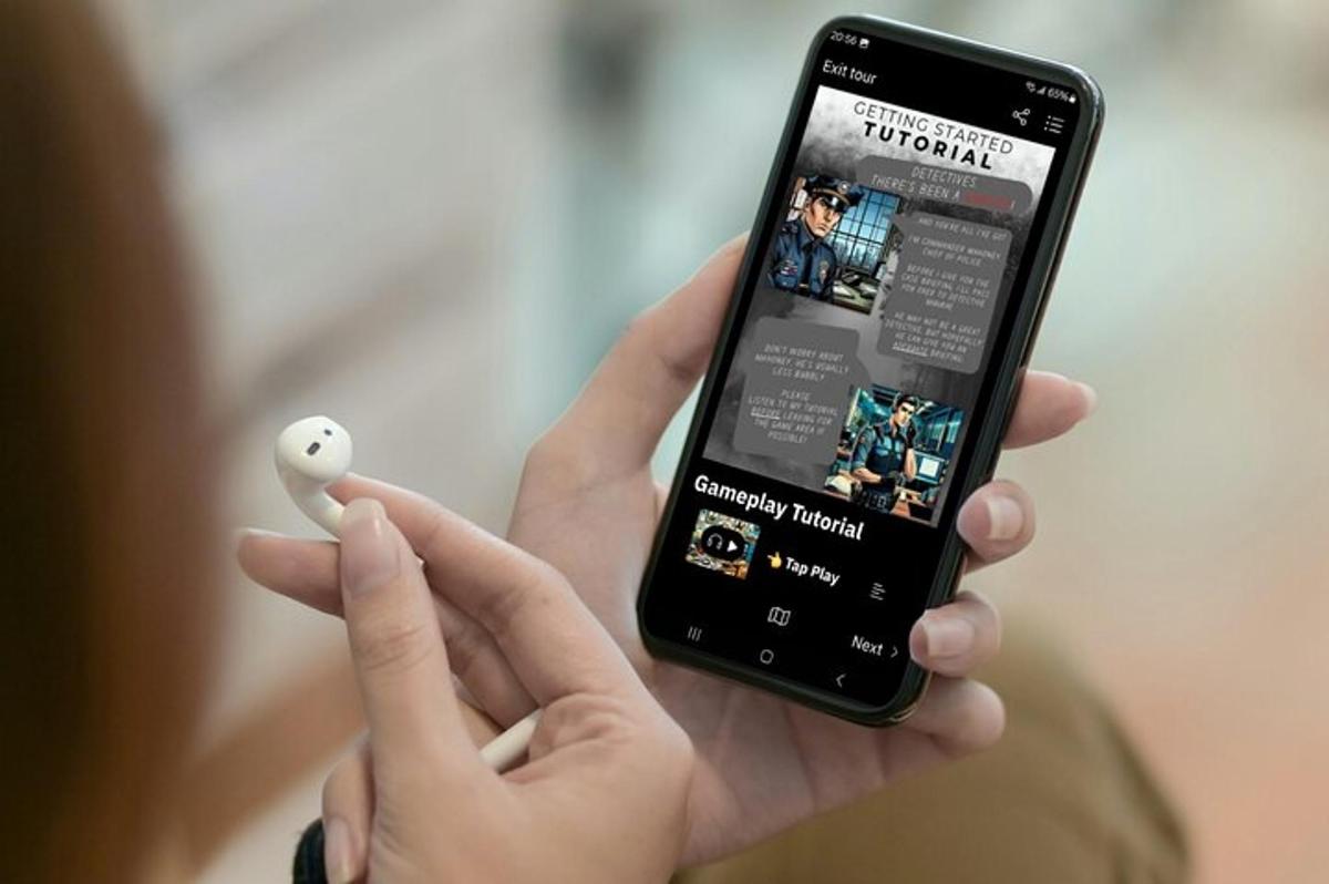 a person holding a smart phone with a video game