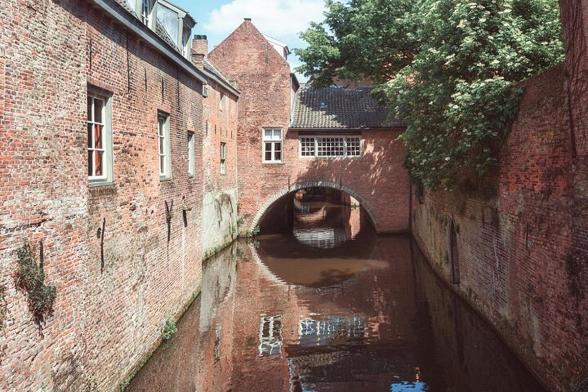 a canal in an alley between two brick buildings