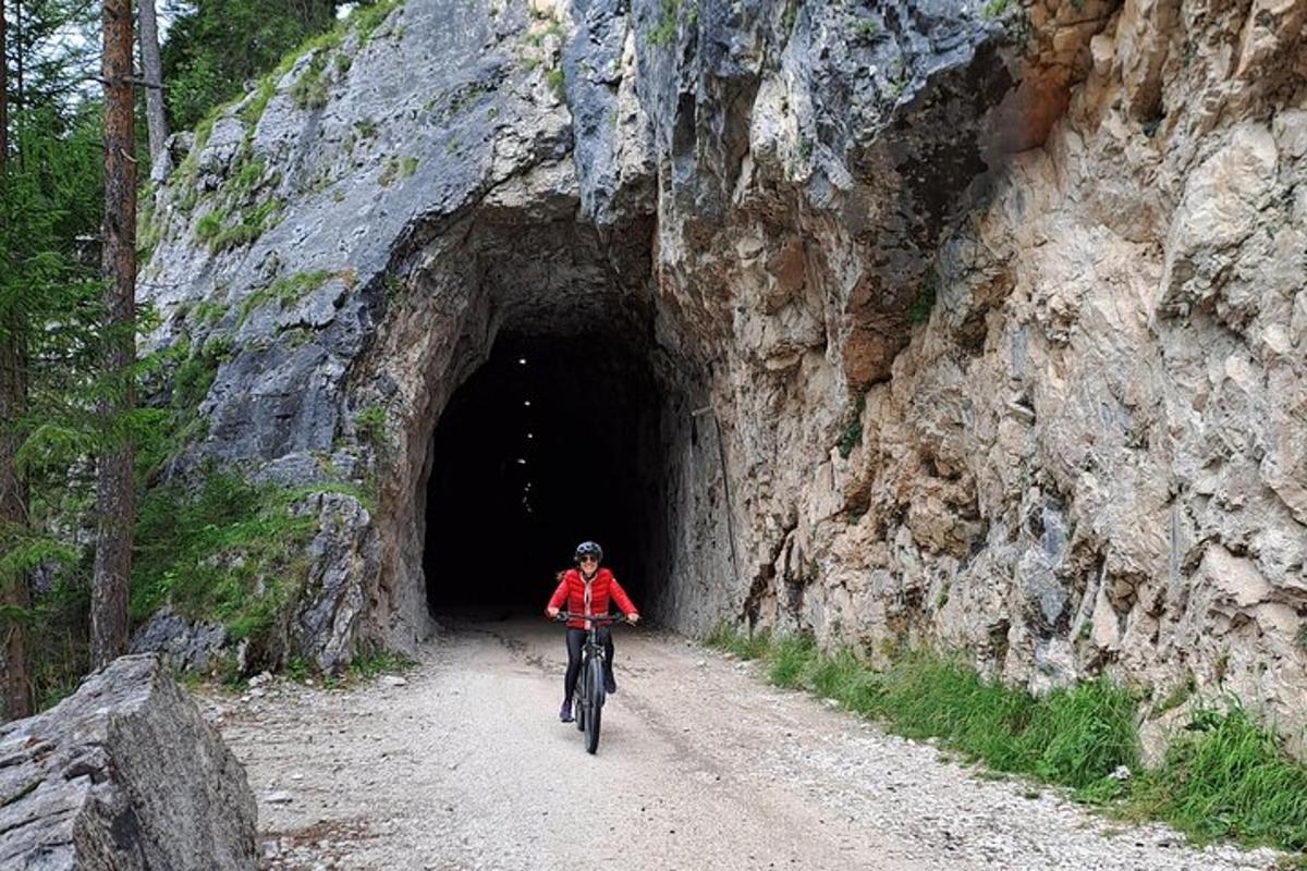 a person riding a bike through a tunnel