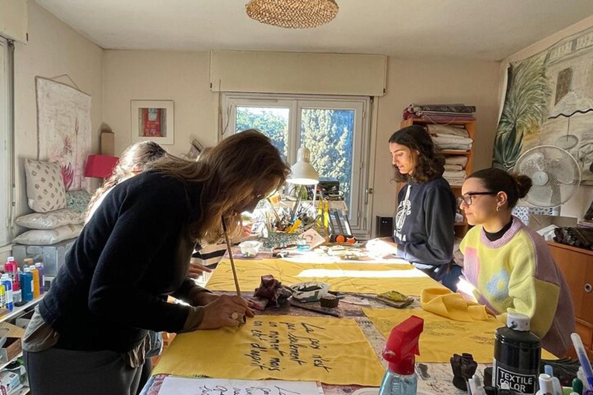 a group of people standing around a table with writing on it