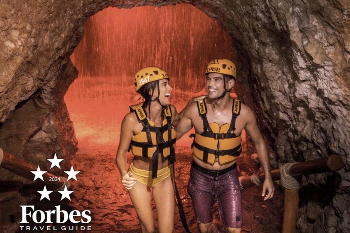 a man and a woman standing in a cave