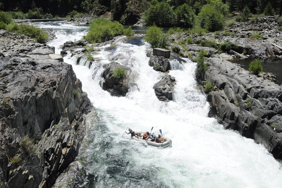 a group of people in a raft in a river