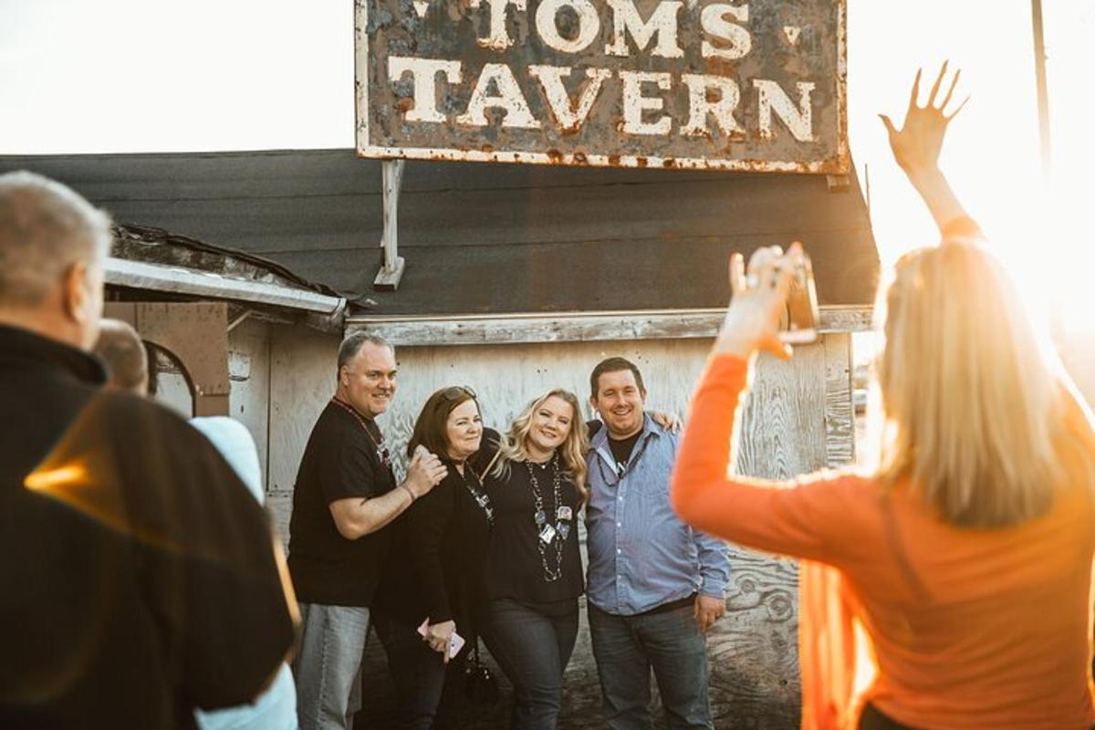 a group of people standing outside of a tavern