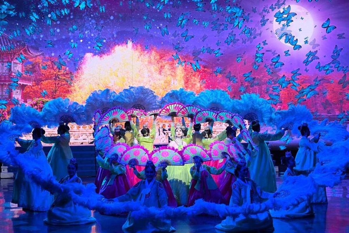 a group of people dancing in front of a stage