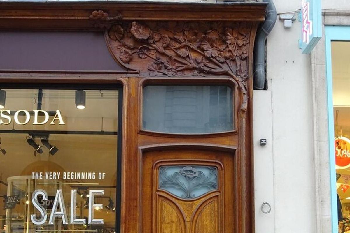 a door to a store with a sale sign on it