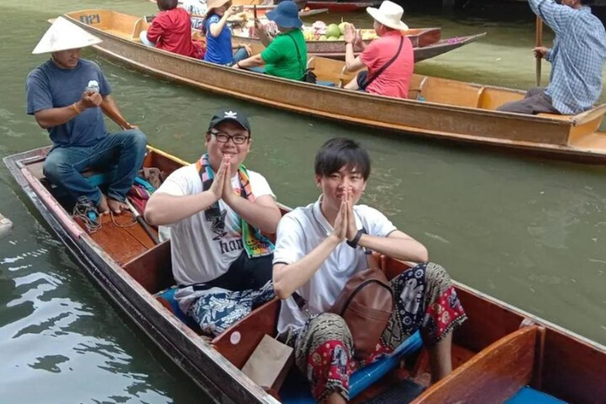 two people sitting in a boat in the water