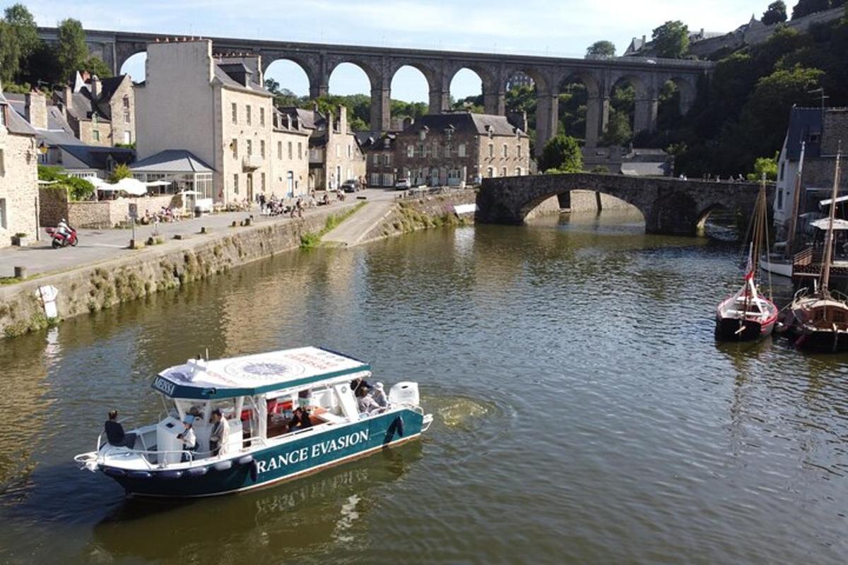 a boat on a river with a bridge in the background