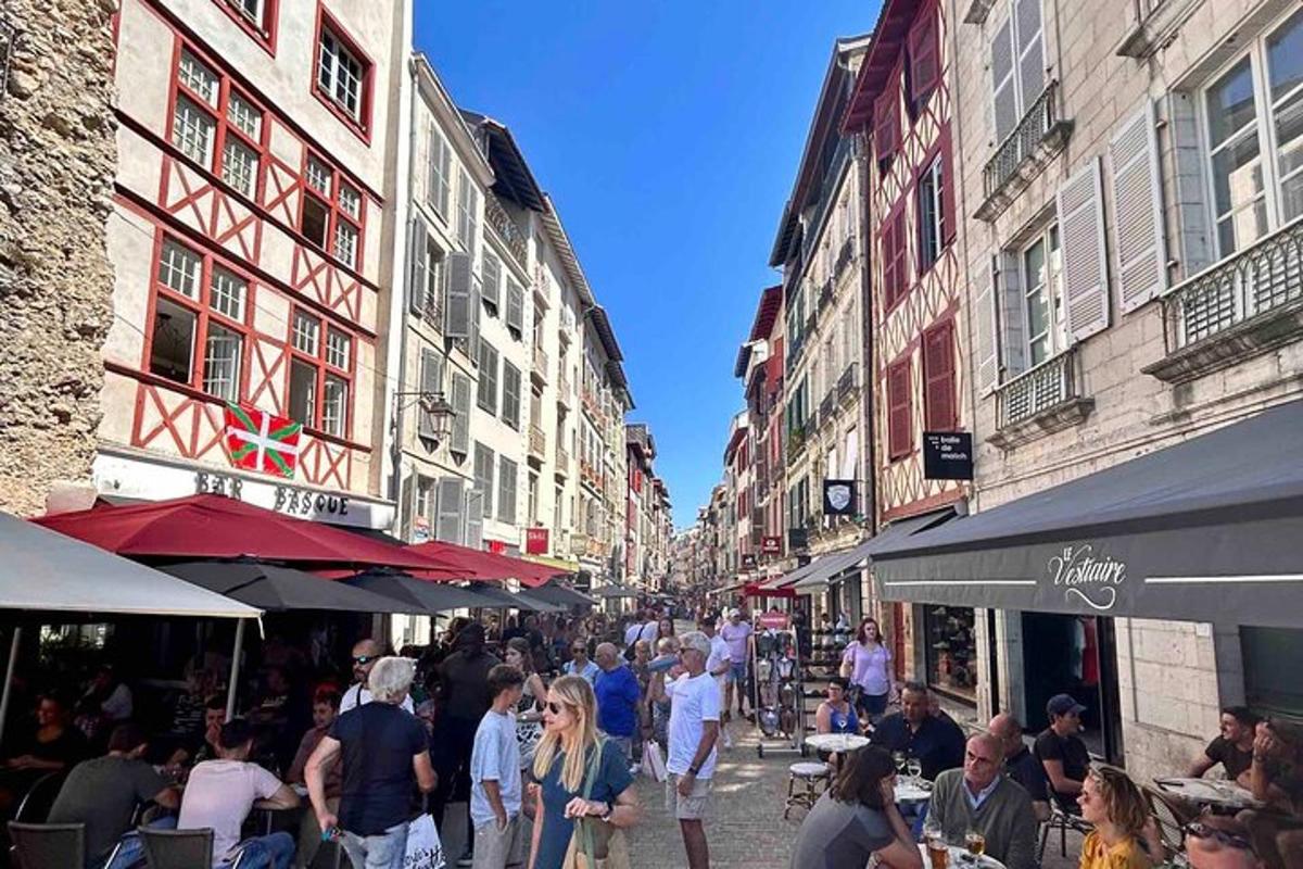 a group of people walking down a street with buildings